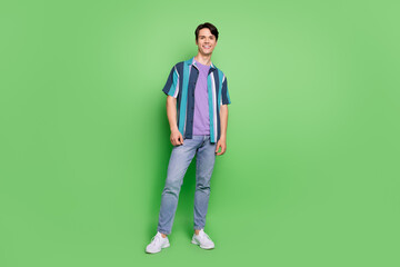 Full body photo of charming happy positive man wear casual clothes smile isolated on green color background
