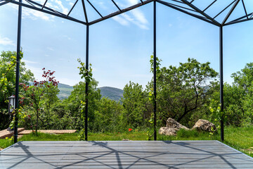 Beautiful veranda with climbing vine and mountain view on a beautiful spring sunny day. Nature...