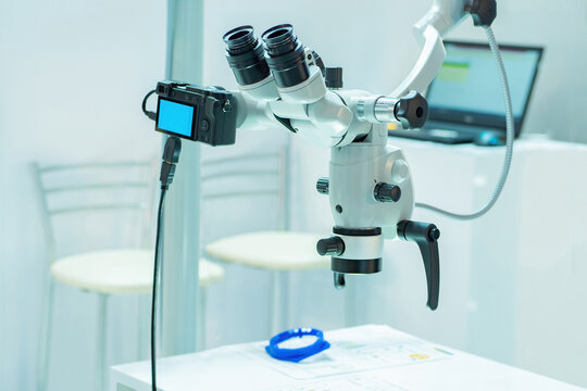 Medical microscope with built-in camera. Electronic microscope in the medical office. Fragment of a surgical microscope. Concept - electronic medical equipment. Human treatment equipment