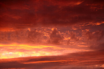 Naklejka na ściany i meble Red sunset sky with dramatic clouds