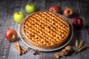 Homemade apple pie with red and green apples around