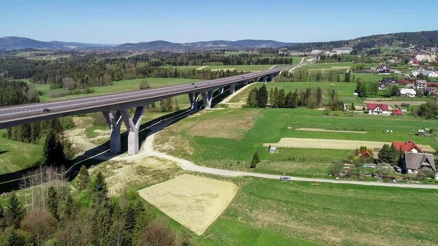 New highway in Poland on national road no 7, E77, called Zakopianka.  Skomielna  Biała village on the right. Aerial 4K approaching video