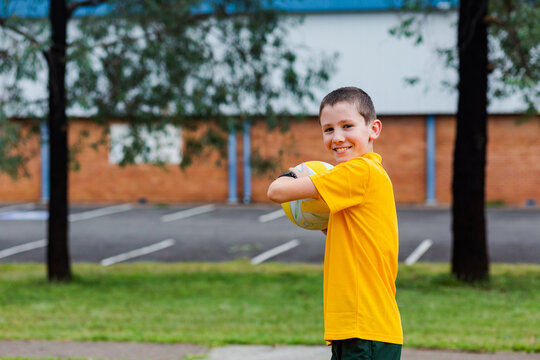 Portrait of Australian primary school child with ball during PE