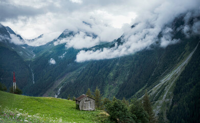 Fototapeta na wymiar Austrian Alps. Mountain landscape cloudy sky and green meadow.