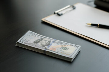 american dollar bills on wooden desk