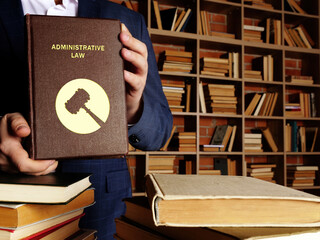 Jurist holds ADMINISTRATIVE LAW book. Administrative law is the body of law that governs the...