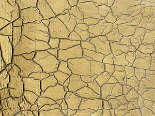 Gold texture as background or design element, swollen old paint on the wall, seamless pattern