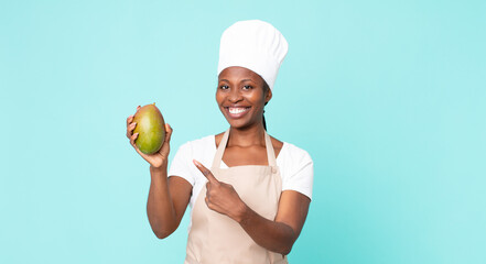 black african american adult chef woman hwith a mango