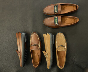 Traditional fabric lace bit loafers for men on a dark textured background for fashion.