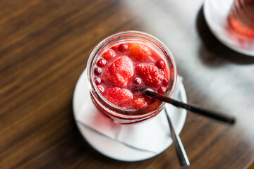 A berry drink with strawberries on the table