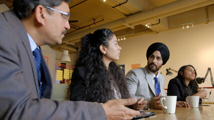 Man wearing the black turban headwear during a meeting