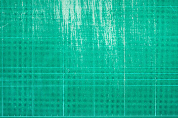 Top view of old green dirty cutting mat, grunge texture background, copy space for text and graphic.