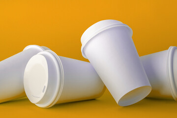 Spilled White Paper Coffee Cups on Green Background, Paper Coffee Cup Template.
