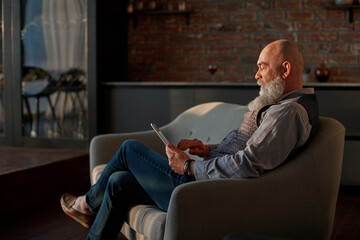 male blogger reading posts on his digital tablet .