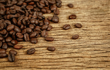 Coffee bean on grunge wooden background.
