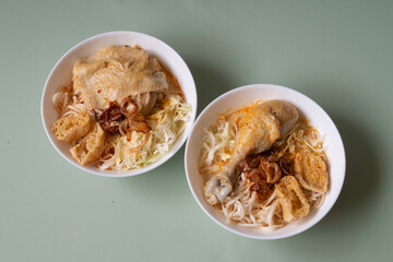 Traditional Asian meal spicy Laksa noodle white curry paste soup with chicken and vegetable from Thailand or Malaysia or Singapore