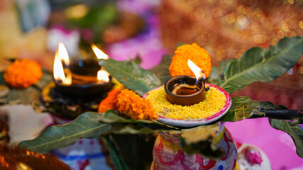 Puja lamp on traditional mango leaves with flowers, also known as Kalash, Hindu festival