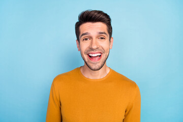 Photo of young cheerful man happy positive smile amazed surprised omg wow excited news isolated over blue color background