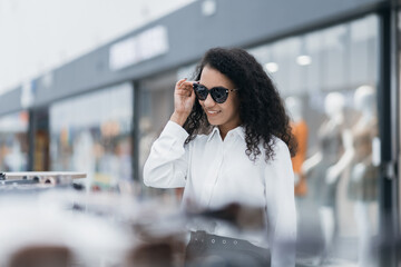 pretty woman trying on sunglasses at the mall.
