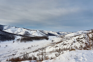 The road between the snow-capped mountains