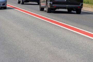 Asphalt road with double lane road stripes  white and red