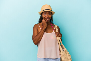 Young african american woman wearing summer clothes isolated on blue background biting fingernails, nervous and very anxious.