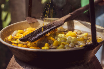 Woman Reeling The Thread, a part for making silk in Thailand.