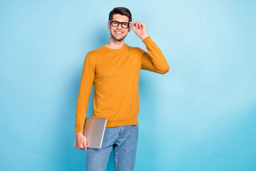 Photo of confident sweet young guy dressed yellow pullover arm glasses holding modern device...