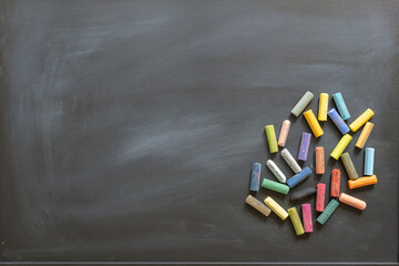 Blackboard with scattered colored chalks
