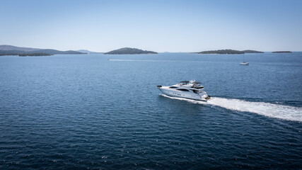 Aerial view of luxury speedboat yacht cruising over mediterranean sea.