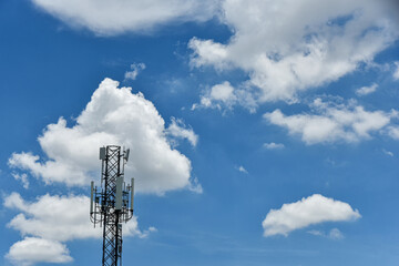 Telecommunication towers with motions clouds on blue sky background.