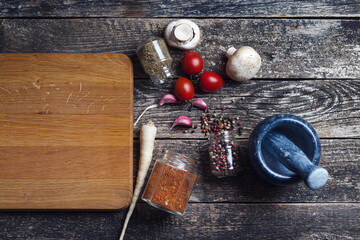 Food background with copy space. Spices and vegetable at kitchen table, top view. Rustic style.