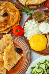 Homemade Romanian Food with grilled fish, polenta, pies, vegetables with red wine. Platter on camping.