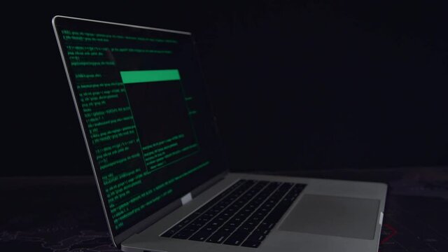 Hacker Concept. Code On A Laptop Computer Monitor In A Dark Room
