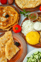 Homemade Romanian Food with grilled fish, polenta, pies, vegetables with red wine. Platter on camping.