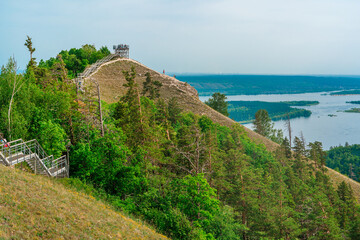 Fototapeta na wymiar Panorama of mountains with a dense forest and the Volga River on the background, photographed from a height. Nature of Russia