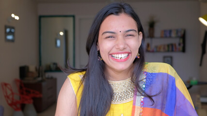 Shallow focus of a beautiful Indian woman with a huge smile on her face