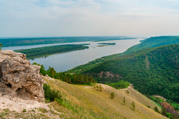 Panorama of mountains with a dense forest and the Volga River on the background, photographed from a height. Nature of Russia