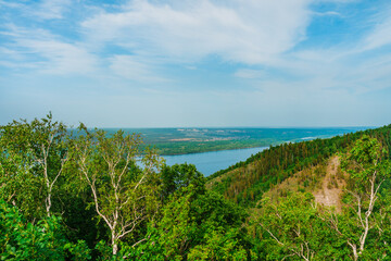 Fototapeta na wymiar Panorama of mountains with a dense forest and the Volga River on the background, photographed from a height. Nature of Russia