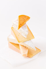 Assortment of different cheeses on white background.
