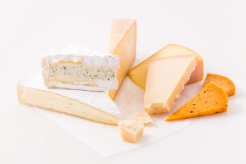 Assortment of different cheeses on white background.