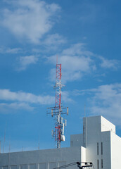 LTE, GSM, 2G, 3G, 4G, 5G tower of cellular communication. Telecommunication tower against the blue sky with clouds.