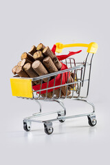 firewood logging. pile of firewood in supermarket trolley cart consumer basket. timber storage of prepared firewood, a bunch of logs, hardwood; Sawed firewood in forest logs close up