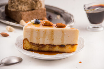 Dessert cheesecake with caramel on a light background
