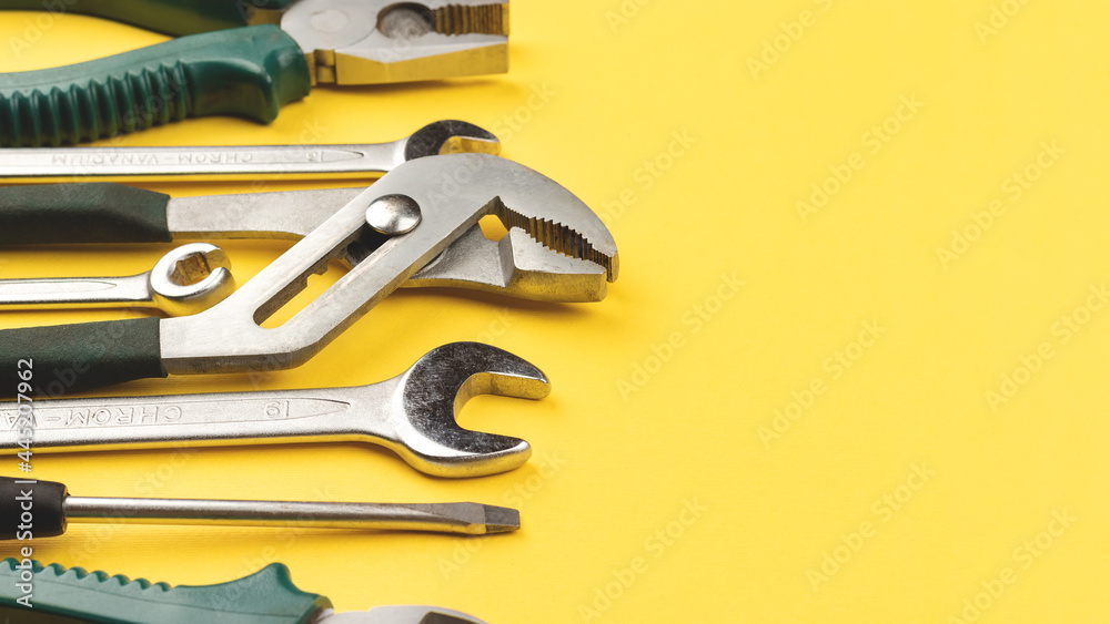 Wall mural Work tools on bright yellow background with copy space. Top view, flat lay