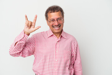 Middle aged indian man isolated on white background showing a horns gesture as a revolution concept.