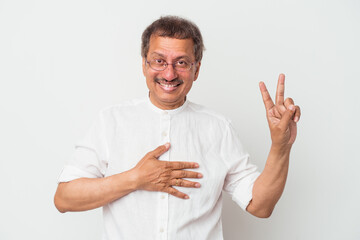 Middle aged indian man isolated on white background taking an oath, putting hand on chest.