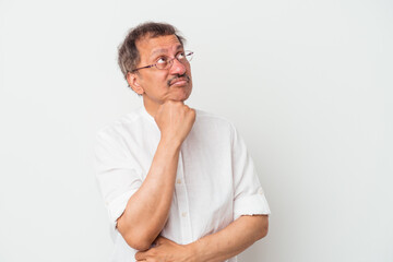 Middle aged indian man isolated on white background thinking and looking up, being reflective, contemplating, having a fantasy.