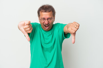 Fototapeta premium Middle aged indian man isolated on white background showing thumb down and expressing dislike.