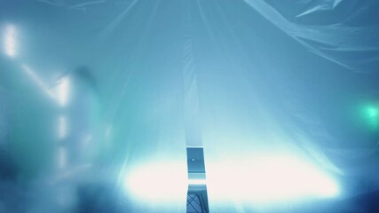 Quarantine zone. Entrance prohibition. Covid-19 restriction. Secret lab research. Strict female scientist in ppe warning with stop hand gesture in blue laboratory tent isolation. - Powered by Adobe